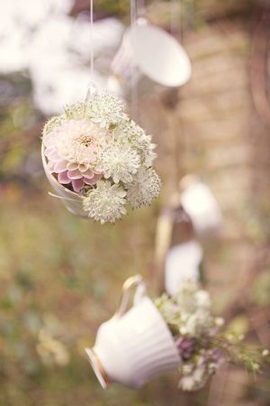 Hanging teacups with flower inside