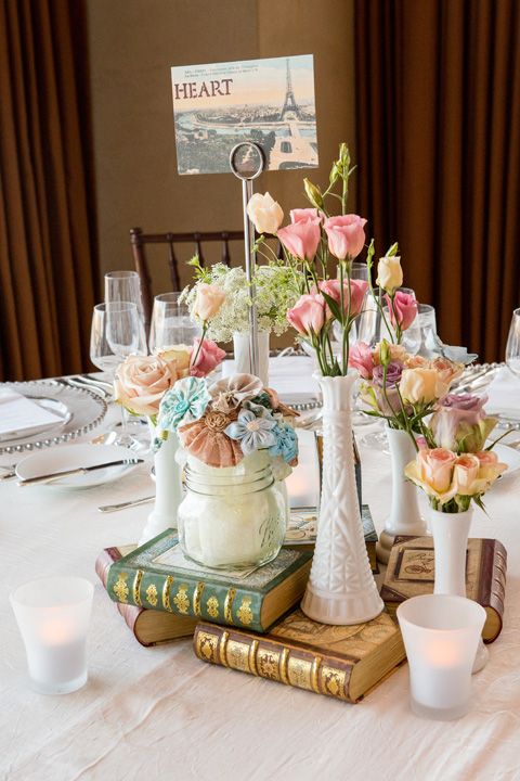 Mix up real flowers with crafted ones and gilded old books for this fab centerpiece