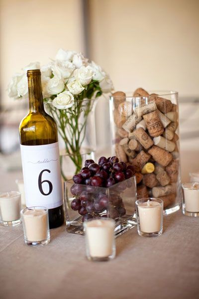 Mixture of wine bottles, lanterns, floral arrangements, corks