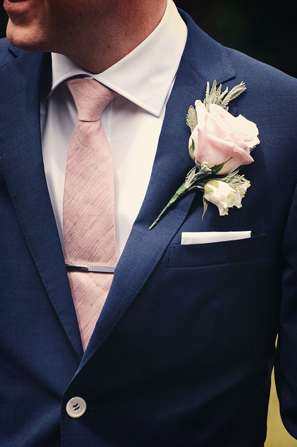 Navy suit, pink heather textured tie, silver tie clip, and rose boutonniere