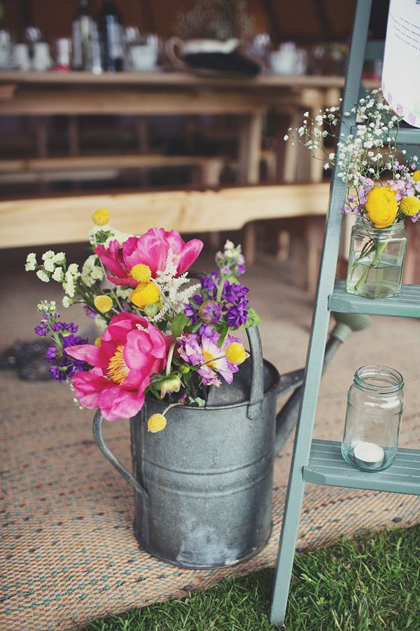 Old bucket as a flower vase inside the tipi reception