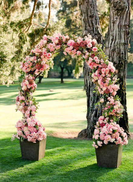 25+ Stuning Wedding Arches with Lots of Flowers 12 Pink flora wedding arch alter climbing roses, Bugle Vine, or Clematis