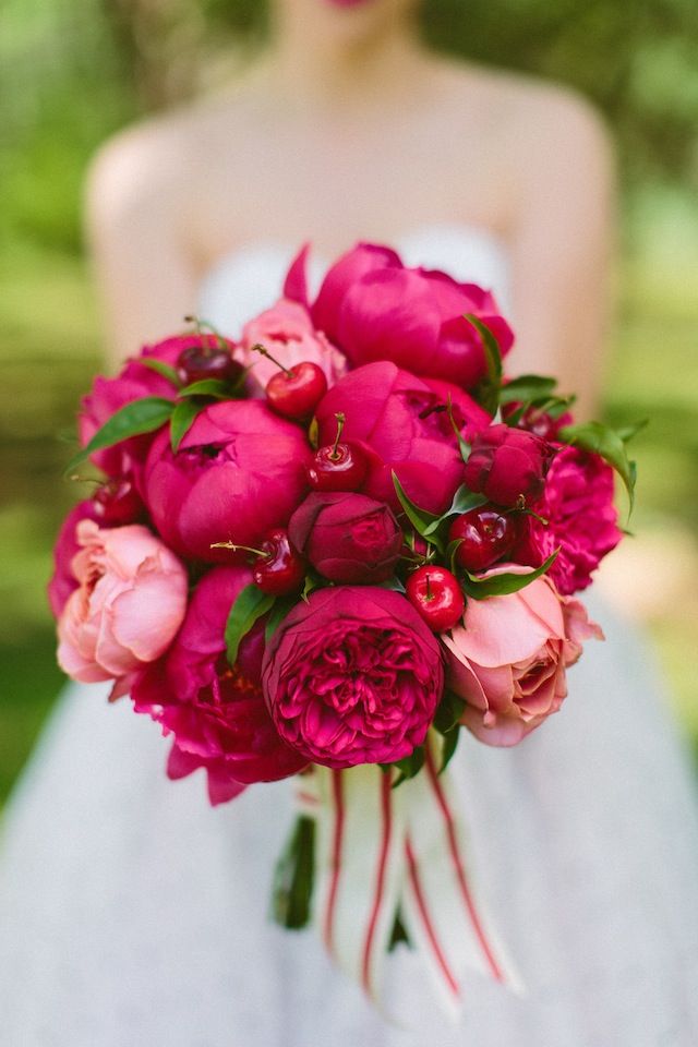 Red peonies bridal bouquet with cherries