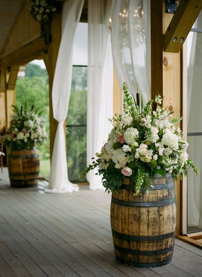 Rustic Wedding Idea- wine barrels with opulent bouquets