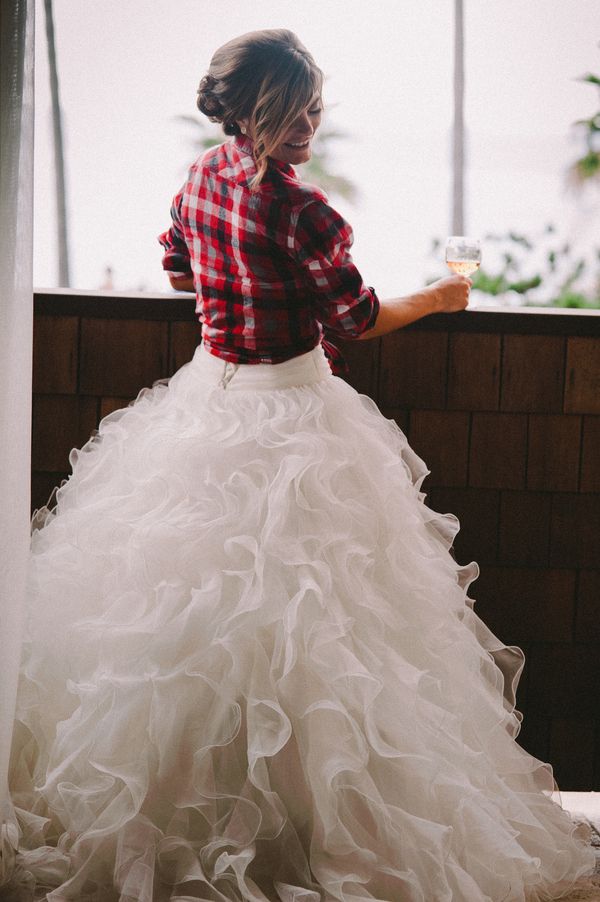 The bride donned a plaid flannel shirt over her gown while she prepped for the wedding