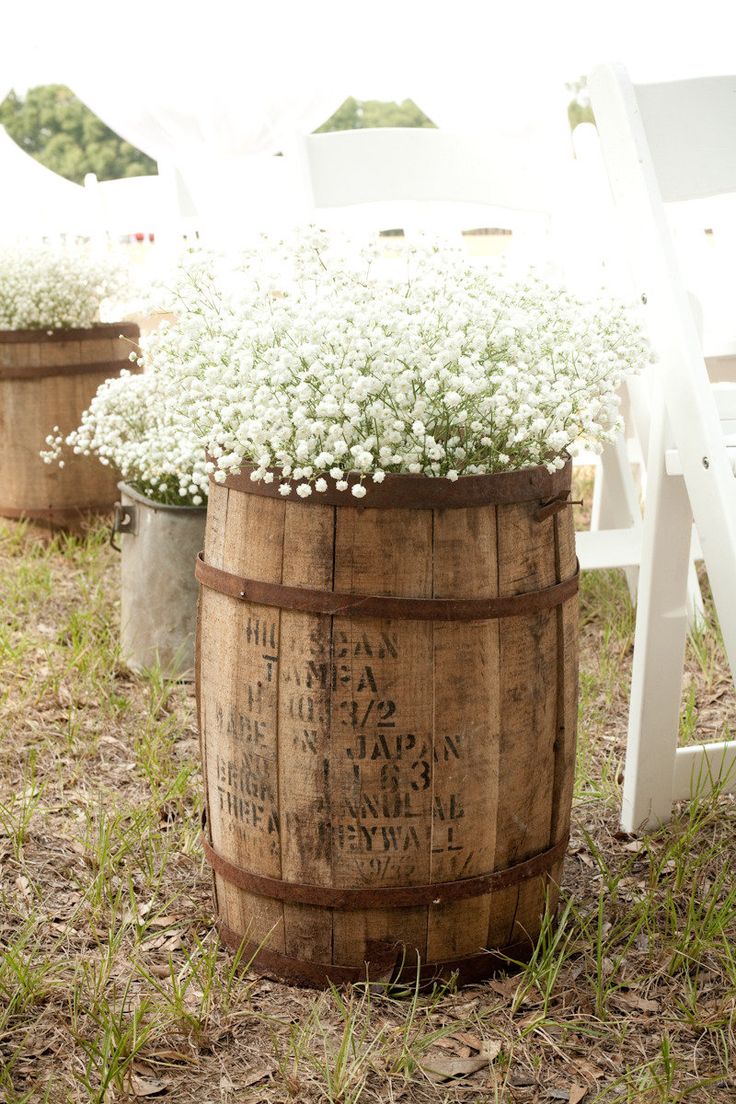 baby's breath and wine barrels ceremony aisle decorations