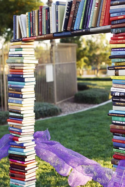 book arch decorated with purple tulle