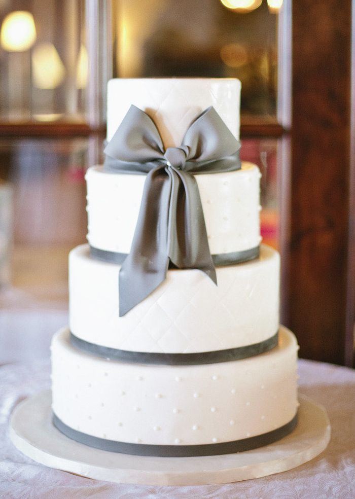 elegant white cake for wedding with sugar silver bow