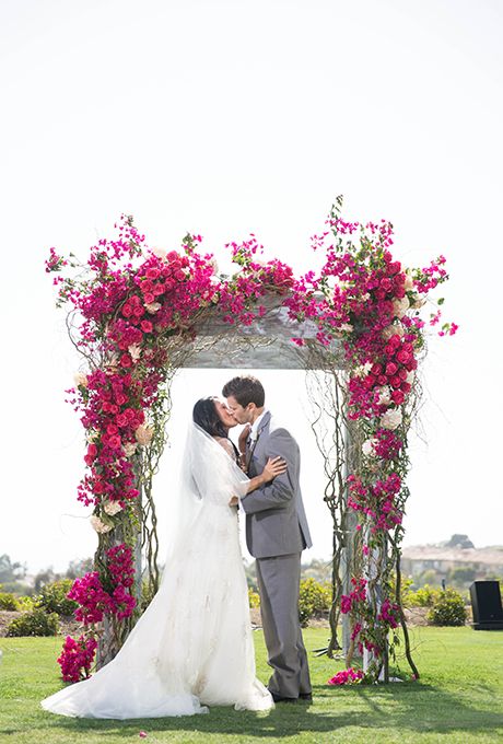 floral arbor covered in bright bougainvillea fushia roses and blush hydrangeas