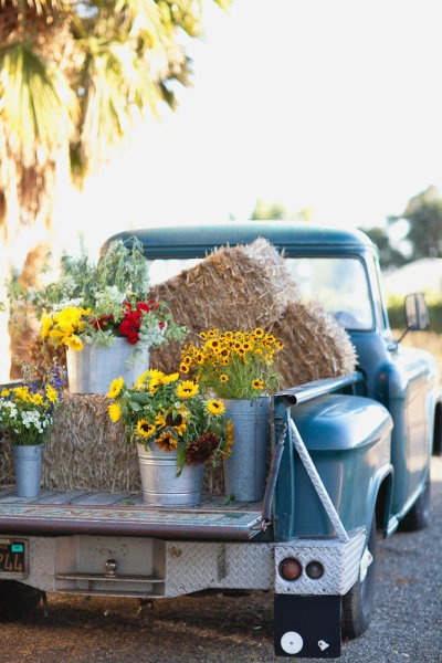 hay bale and sunflowers on a old pickup truck wedding decor ideas