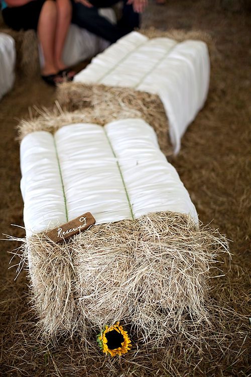 haybale wedding seating with white fabric