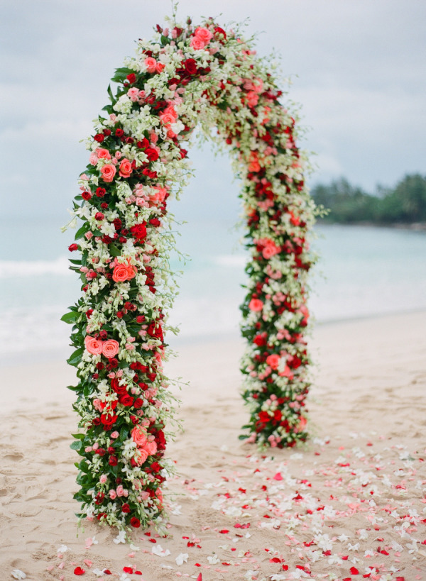 red pink and white flowers beach wedding arch