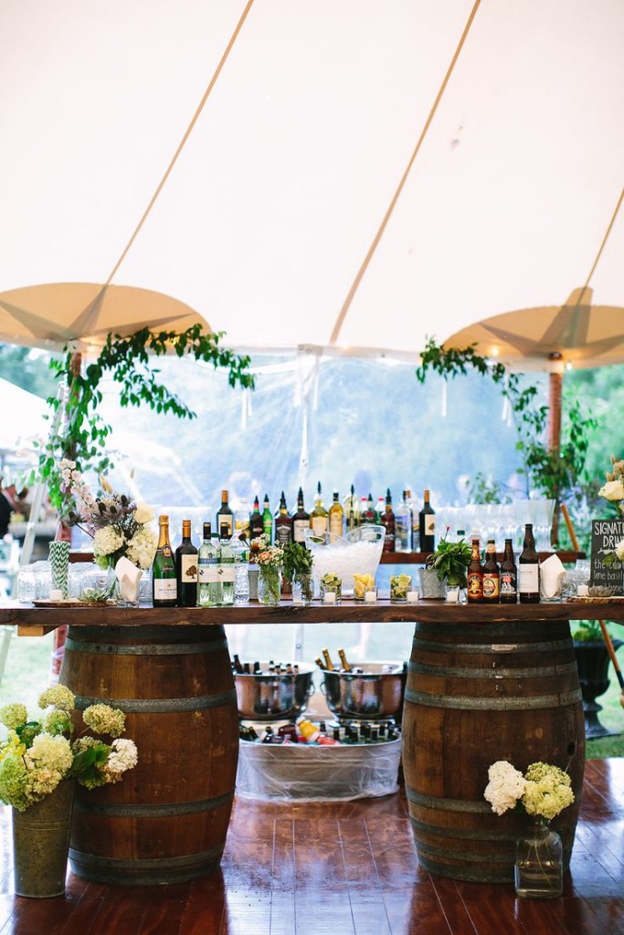 rustic wedding table ideas-The wine casks and a rustic plank makes for an easy outdoor bar setup