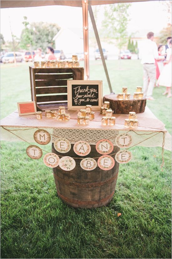 shabby chic wedding favor table with small jars of honey for guests to take home