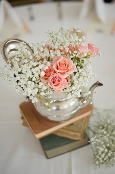 wedding floral arrangement with tea pot and vintage books wedding ideas