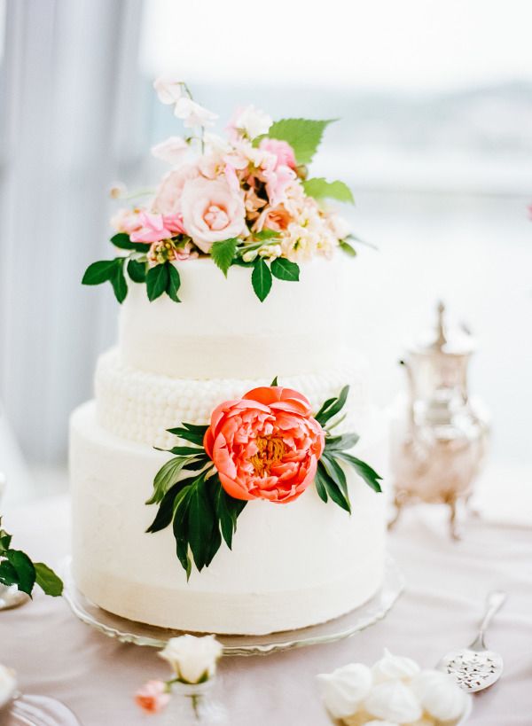 white wedding cake with flowers detailed center tier