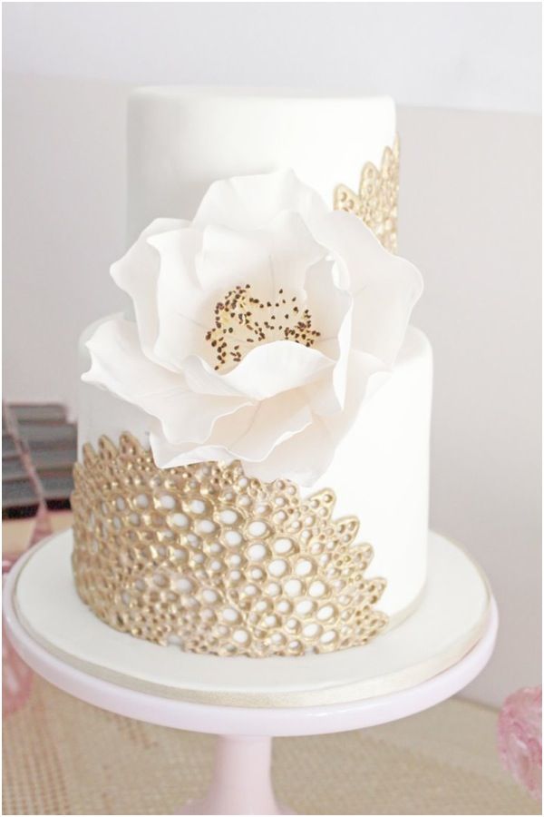 white wedding cake with gold lace