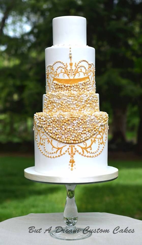 white wedding cake with sugar gold pearls