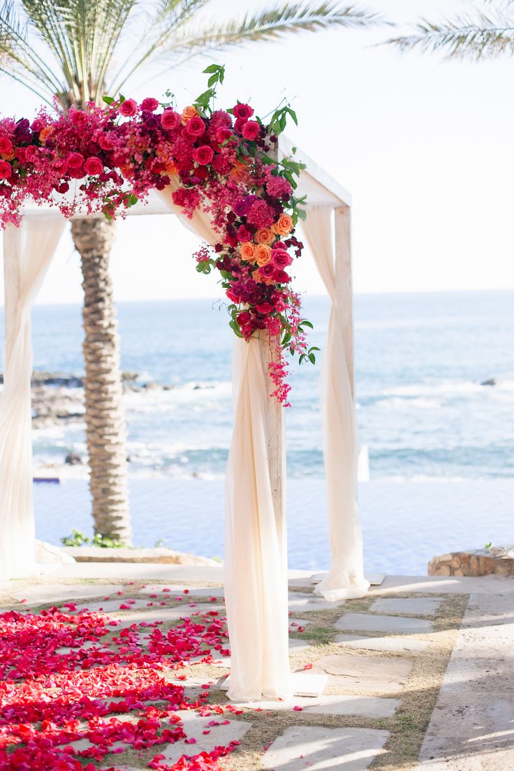 Beach wedding ideas- Beach ceremony drenched in flowers