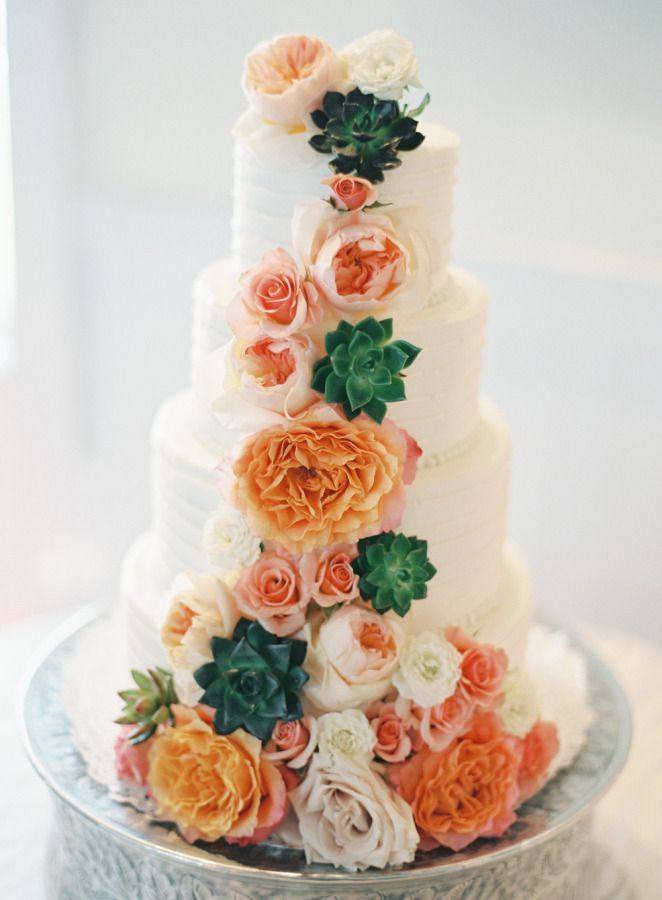 Flower covered white buttercream wedding cake
