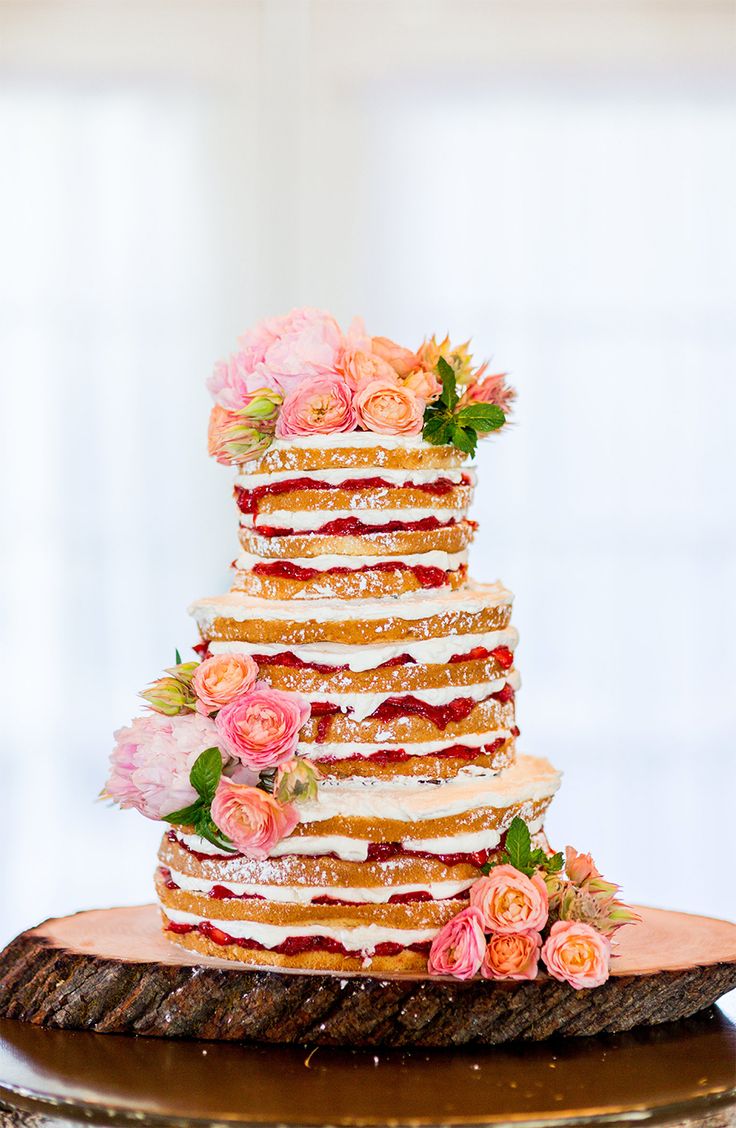 Naked wedding cake with pink flowers
