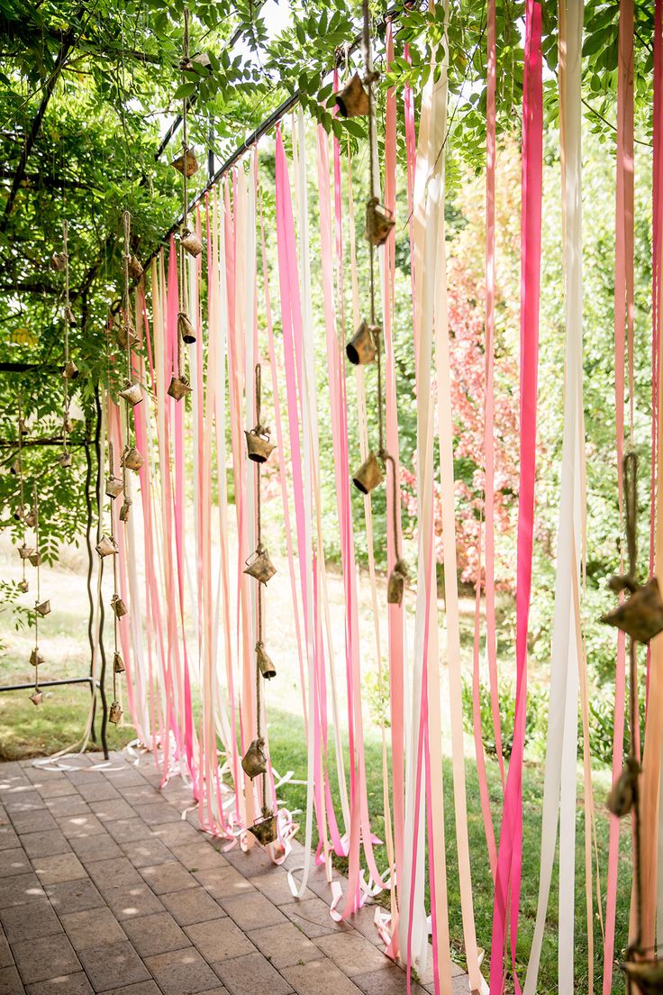 45+ Coral Wedding Color Ideas You Don't Want to Overlook 34 Pink Coral Ribbon Backdrop Wall and Cow Bells