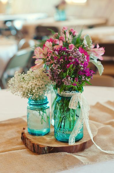 Rustic floral with blue mason jar and wood wedding centerpiece