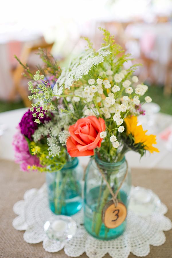 Springy floral centerpieces in blue mason jars