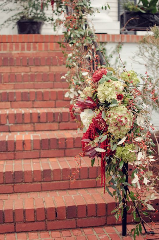 Staircase covered with florals at wedding ceremony