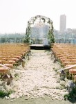 White rose petals blanketing the aisle