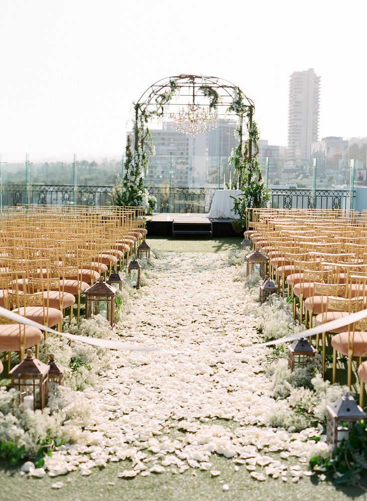 White rose petals blanketing the aisle