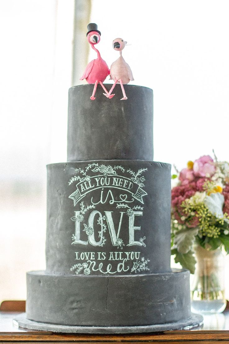 chalkboard wedding cake with flamingo toppers