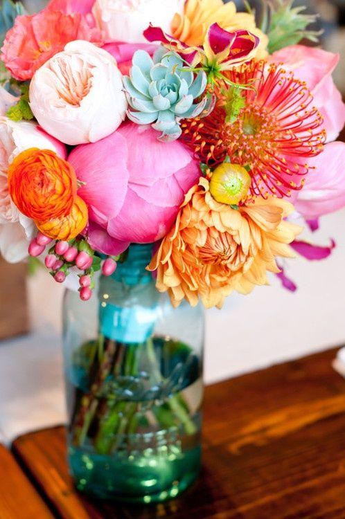 colorful bridal bouquet in blue mason jar