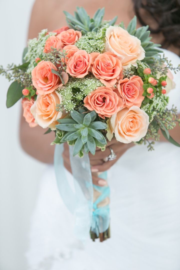 coral roses and green succulents wedding bouquet