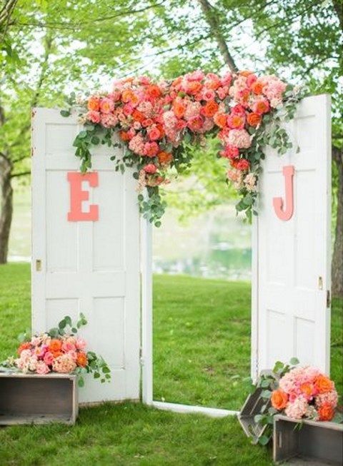 coral roses and white door wedding backdrop