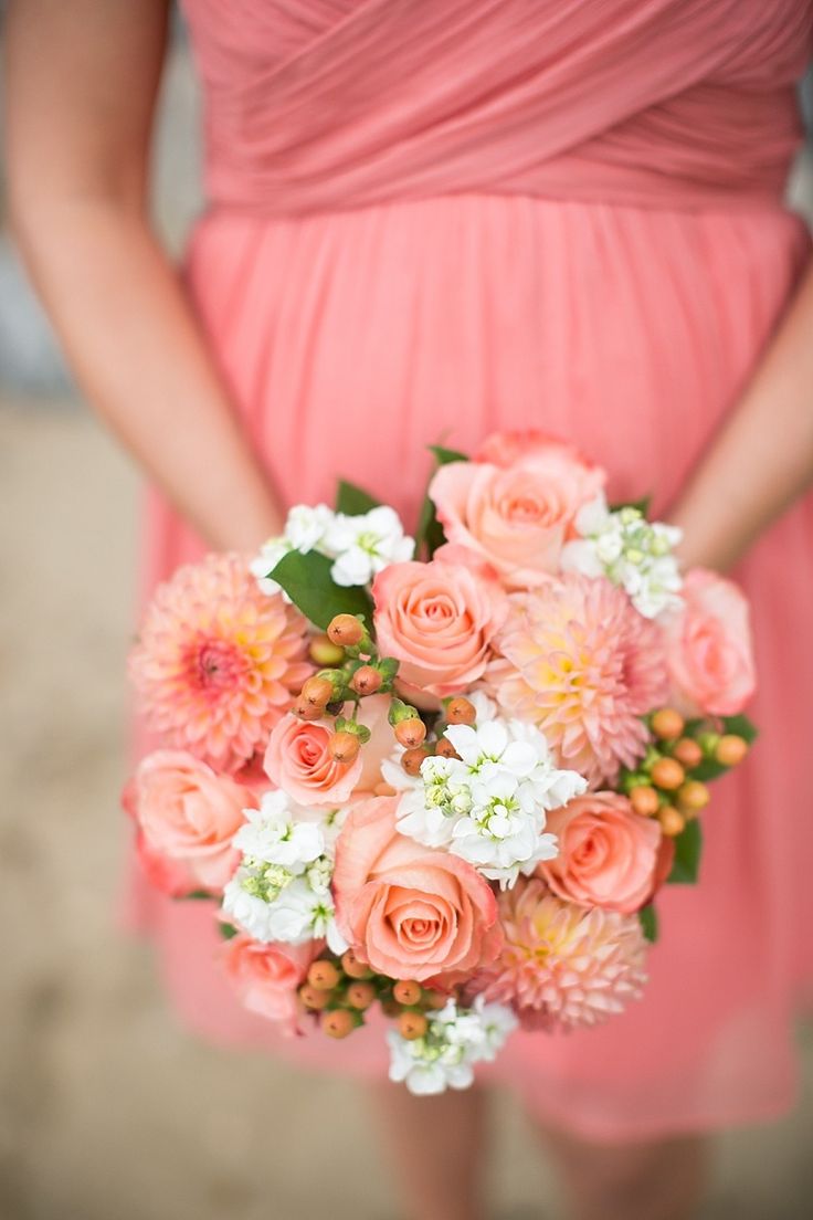 coral wedding bouquet and bridesmaid dress