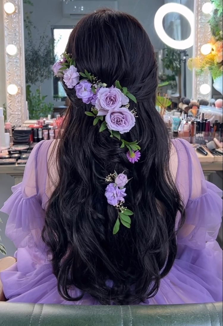 half up half down quinceanera hairstyle down with purple flowers