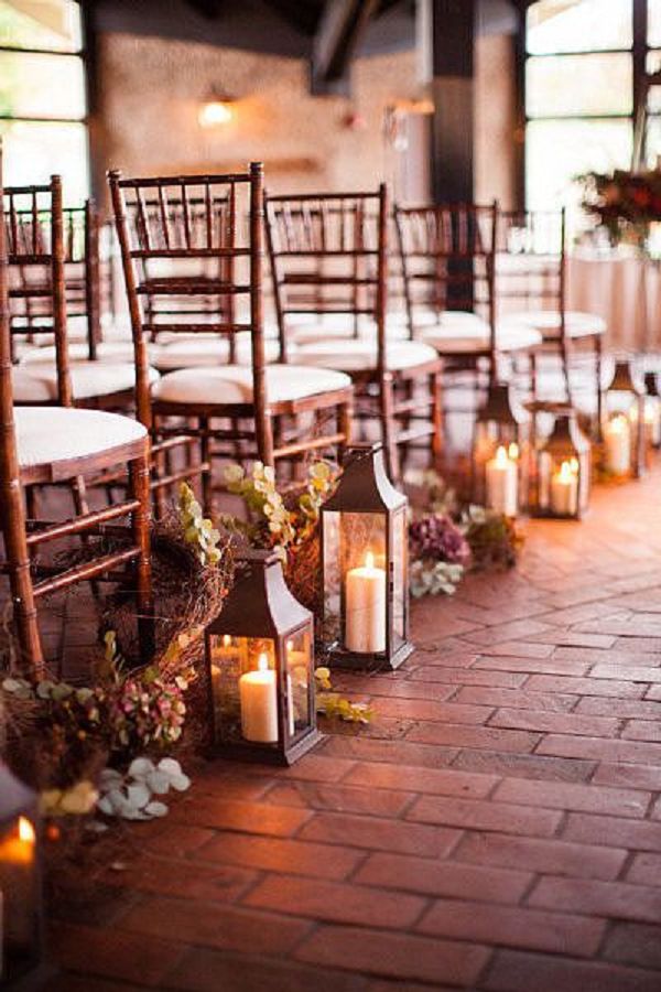 indoor lanterns and flowers wedding aisle