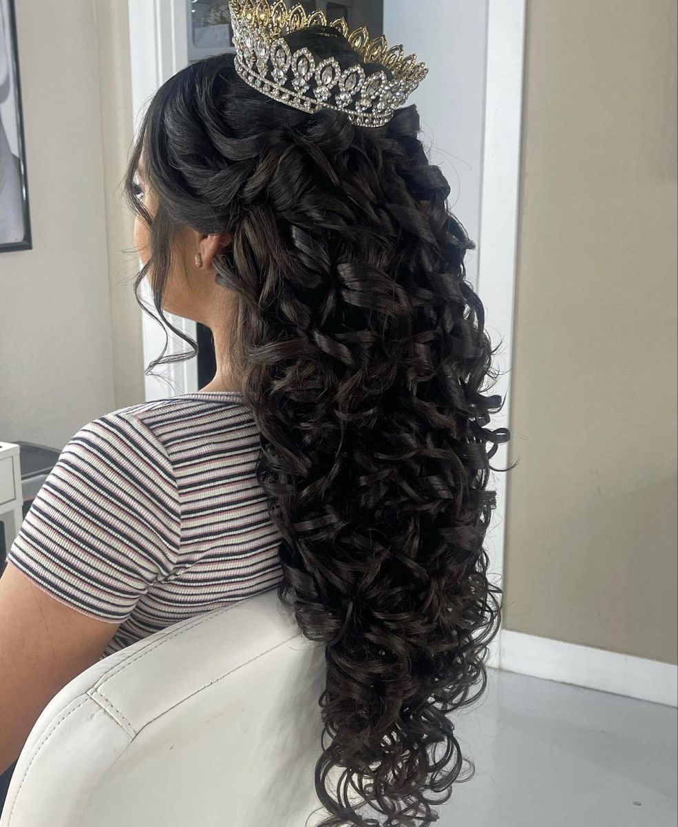 long wavy quinceanera hairstyle down with a crown
