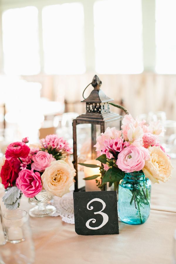 pastel pink flowers in blue mason jar with table number ideas