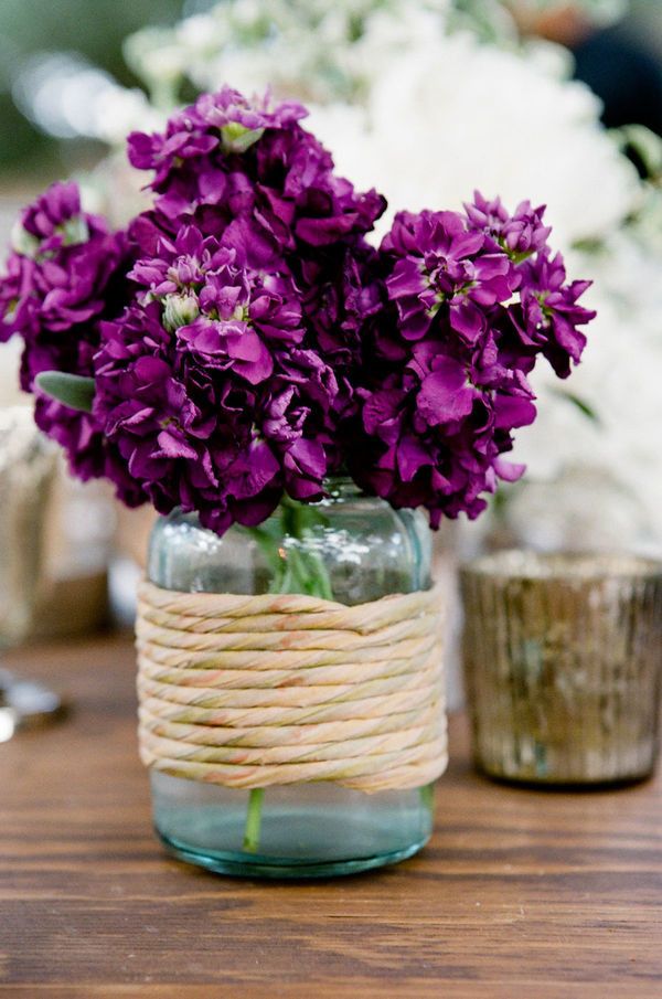 purple flowers in blue mason jar wedding centerpieces