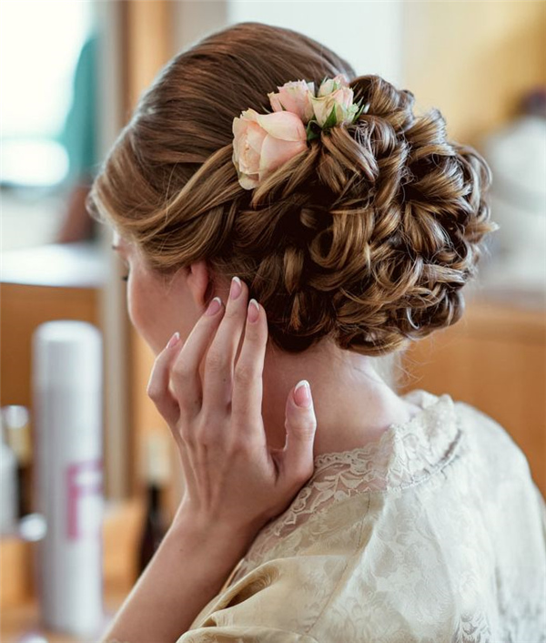 updo wedding hairstyle with pink flower