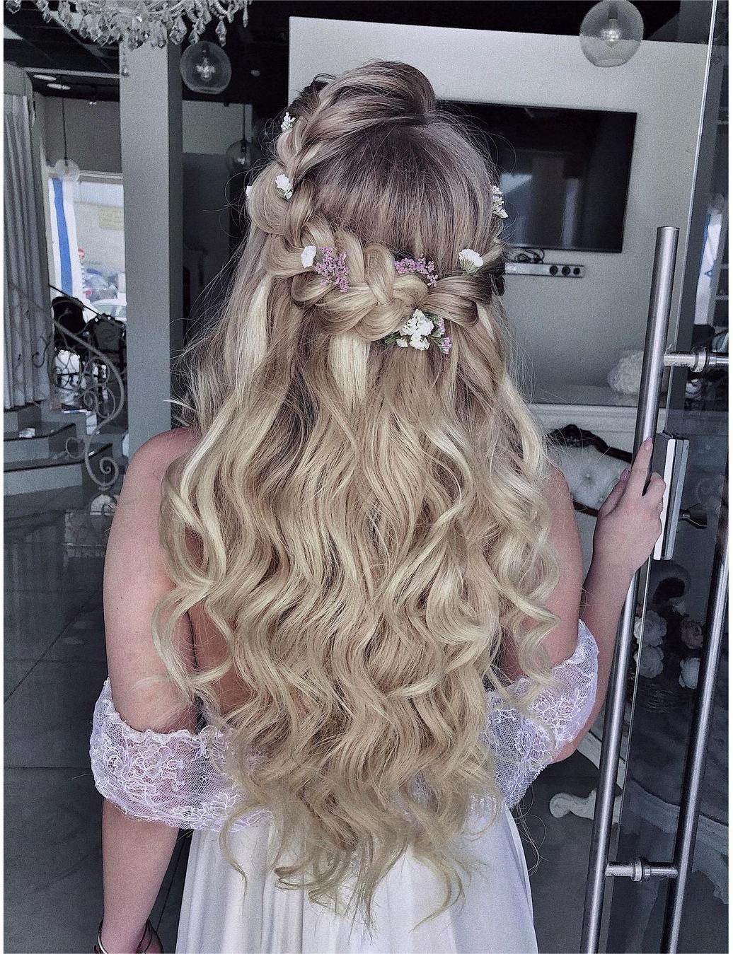 waterful half up half down braided wedding hairstyle with flowers via zhanna_syniavska