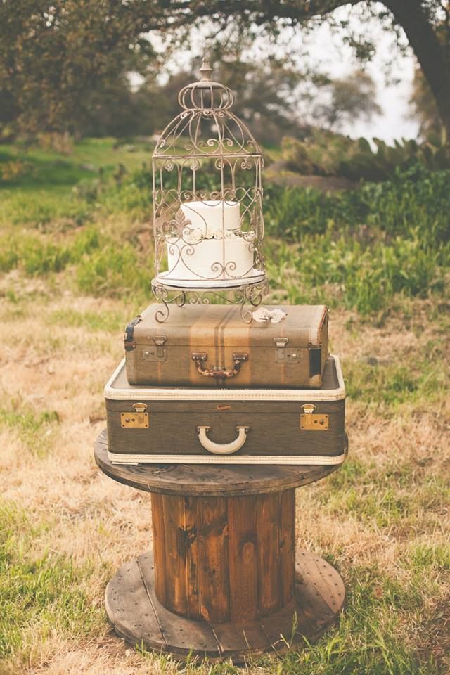 wedding cake in a cage on vintage rustic suitcase