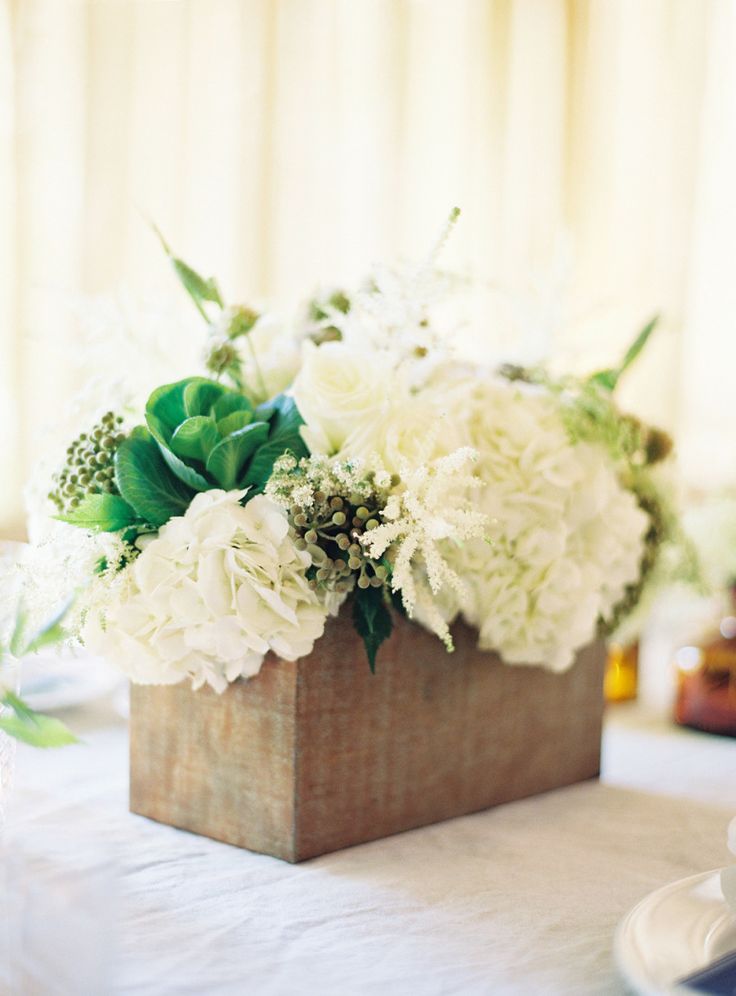 white and green flowers in wooden box