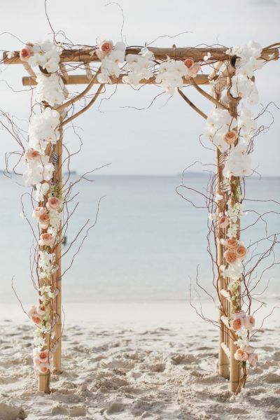 white flowers wedding arch for beach weddding