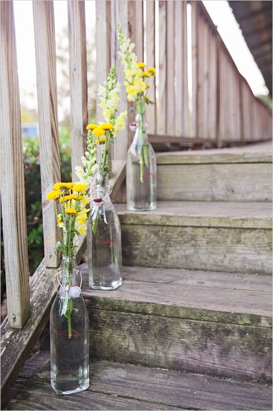 wildflowers in glass bottles brighten up a staircase