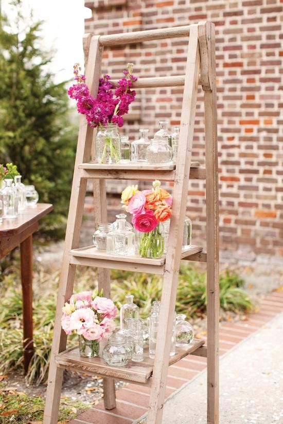 Flower display on a vintage ladder at the entrance to the wedding ceremony