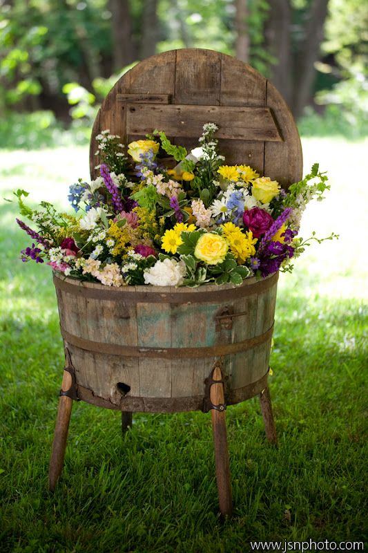 Old Rustic Barrel Planter with flowers for a wine country wedding ceremony reception