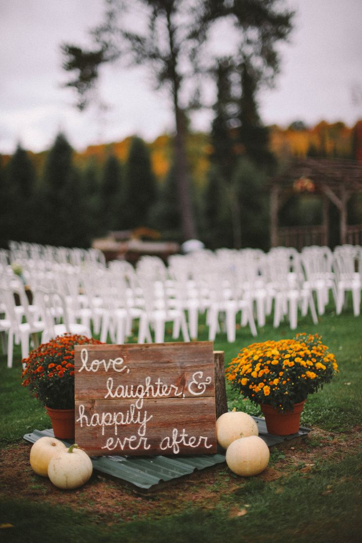 Outdoor Fall Wedding Ceremony with love the sign and pumpkins